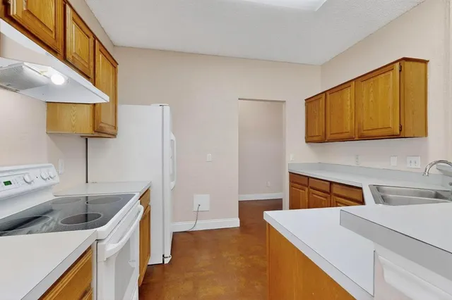 a kitchen that has a sink and a stove in it
