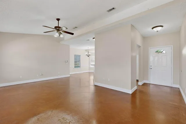 a view of room with hardwood floor and ceiling fan