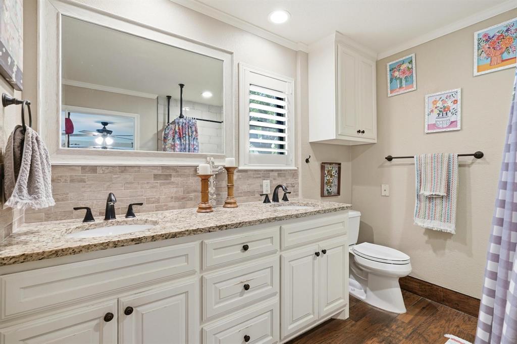 432 Clark Road Abilene, TX 79602 - Photo 16 of 40 a bathroom with a granite countertop sink mirror and toilet
