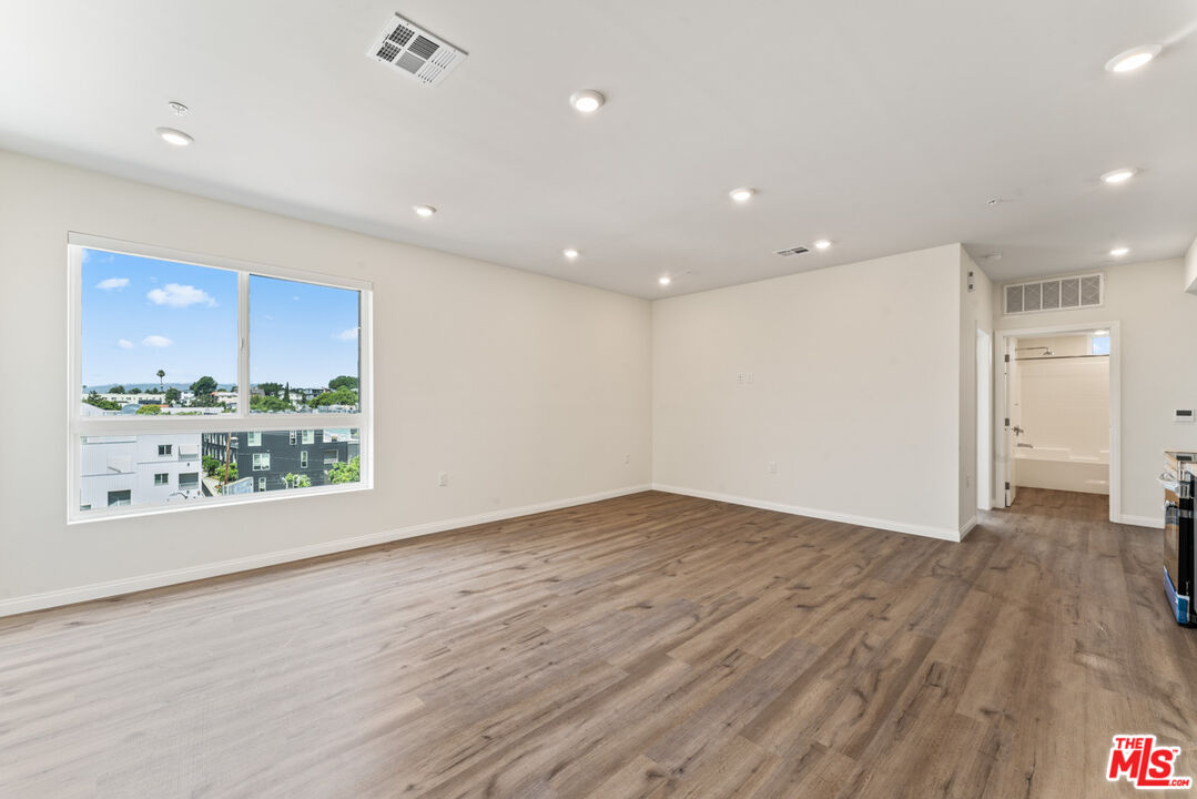 3105 Bellevue Avenue, Unit 204 Los Angeles, CA 90026 - Photo 2 of 20 a view of an empty room with a window and wooden floor