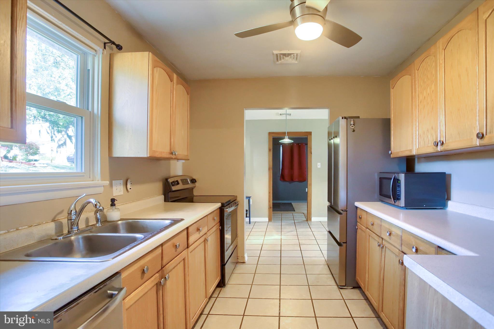 4709 Delbrook Road Mechanicsburg, PA 17050 - Photo 13 of 34 a kitchen with a sink stove and cabinets