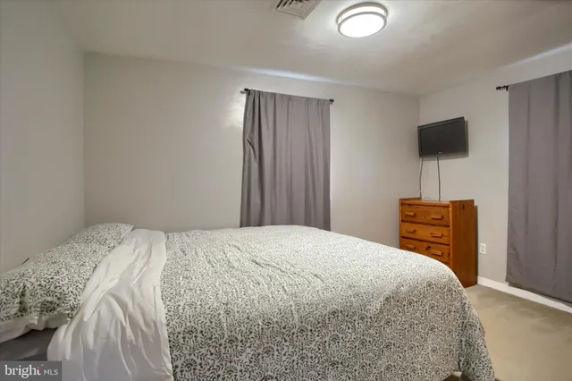 a bedroom with a bed and a television