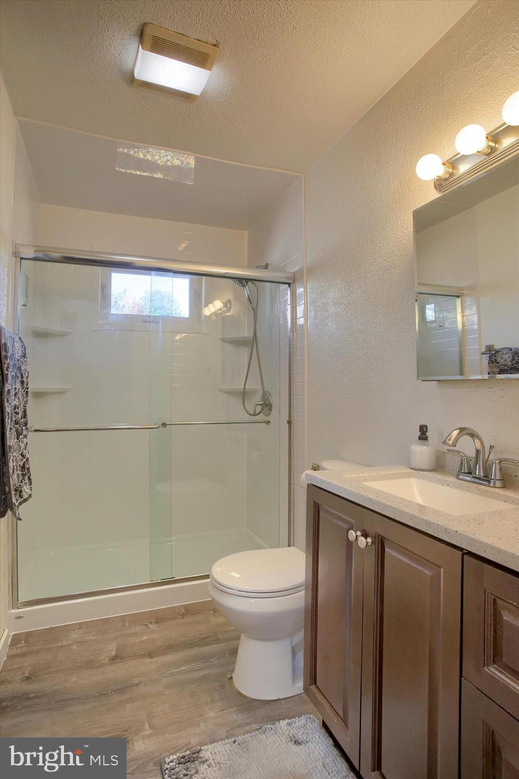 4709 Delbrook Road Mechanicsburg, PA 17050 - Photo 18 of 34 a bathroom with a granite countertop sink toilet and shower