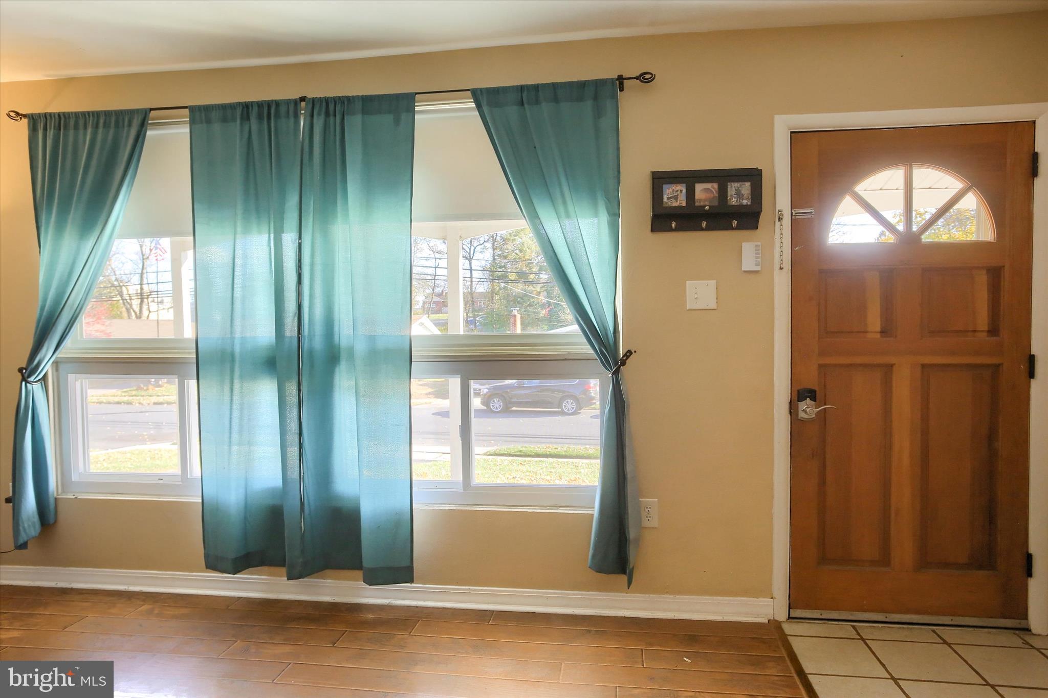 4709 Delbrook Road Mechanicsburg, PA 17050 - Photo 5 of 34 a view of a livingroom with a large window and wooden floor