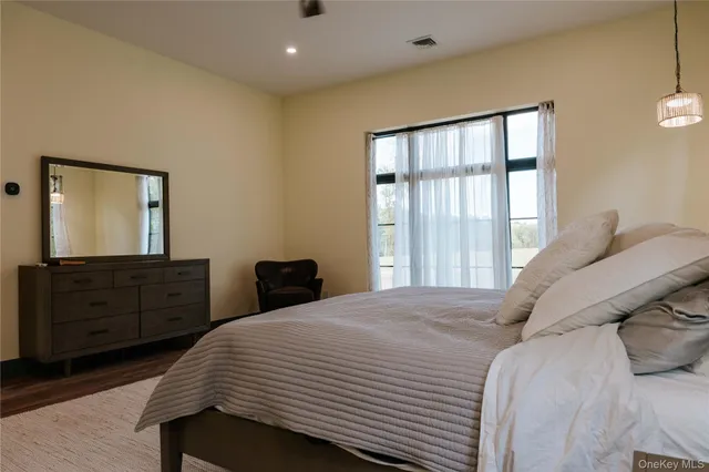 a bedroom with a bed and a dresser