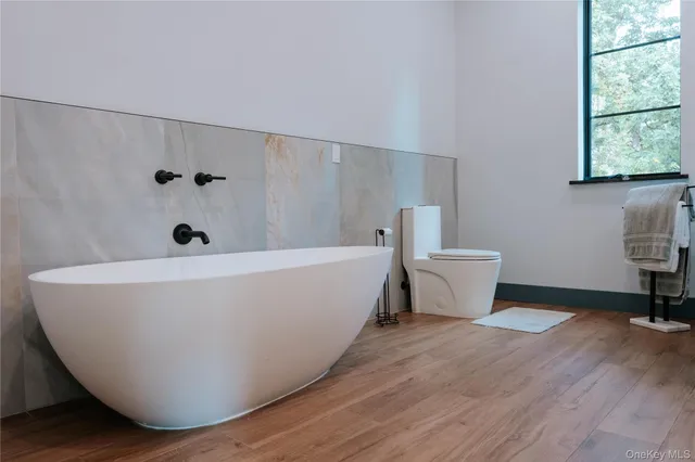 a white bath tub sitting in a bathroom