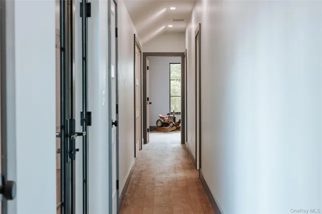 a view of a hallway with a livingroom and a bathroom with sink