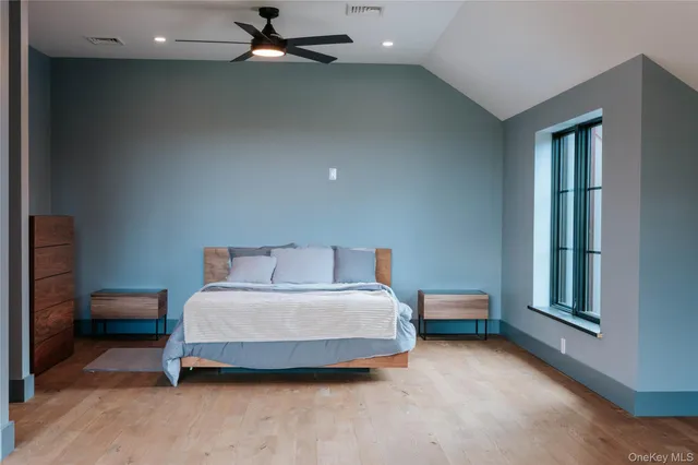 a spacious bedroom with a bed and a window