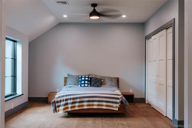 a bedroom with a bed and a window