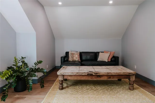 a bedroom with a bed and a potted plant