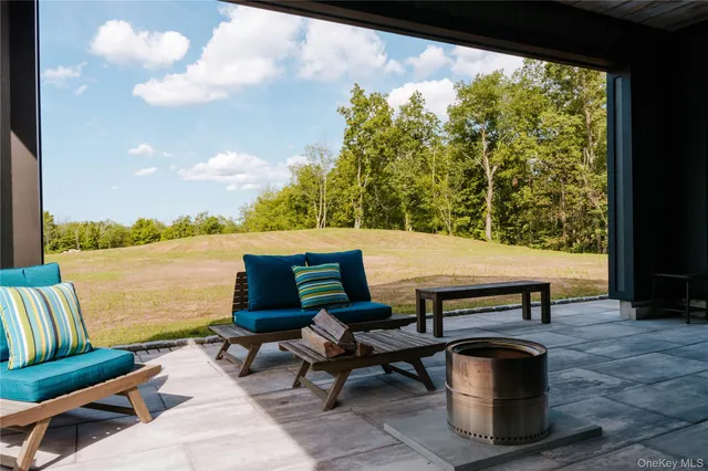 a sitting area with lake view and a potted plant