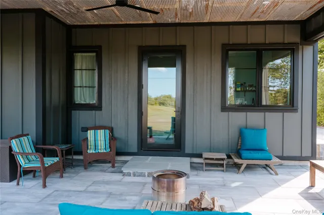 a outdoor seating area with furniture and windows