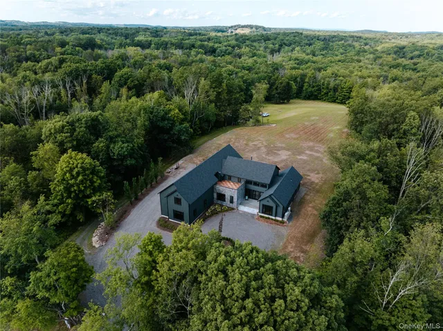 an aerial view of a house with mountain view