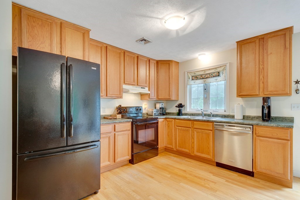 71 Rindge State Road Ashburnham, MA 01430 - Photo 14 of 26 a kitchen with stainless steel appliances granite countertop a refrigerator a sink dishwasher a stove top oven a refrigerator with island and chairs