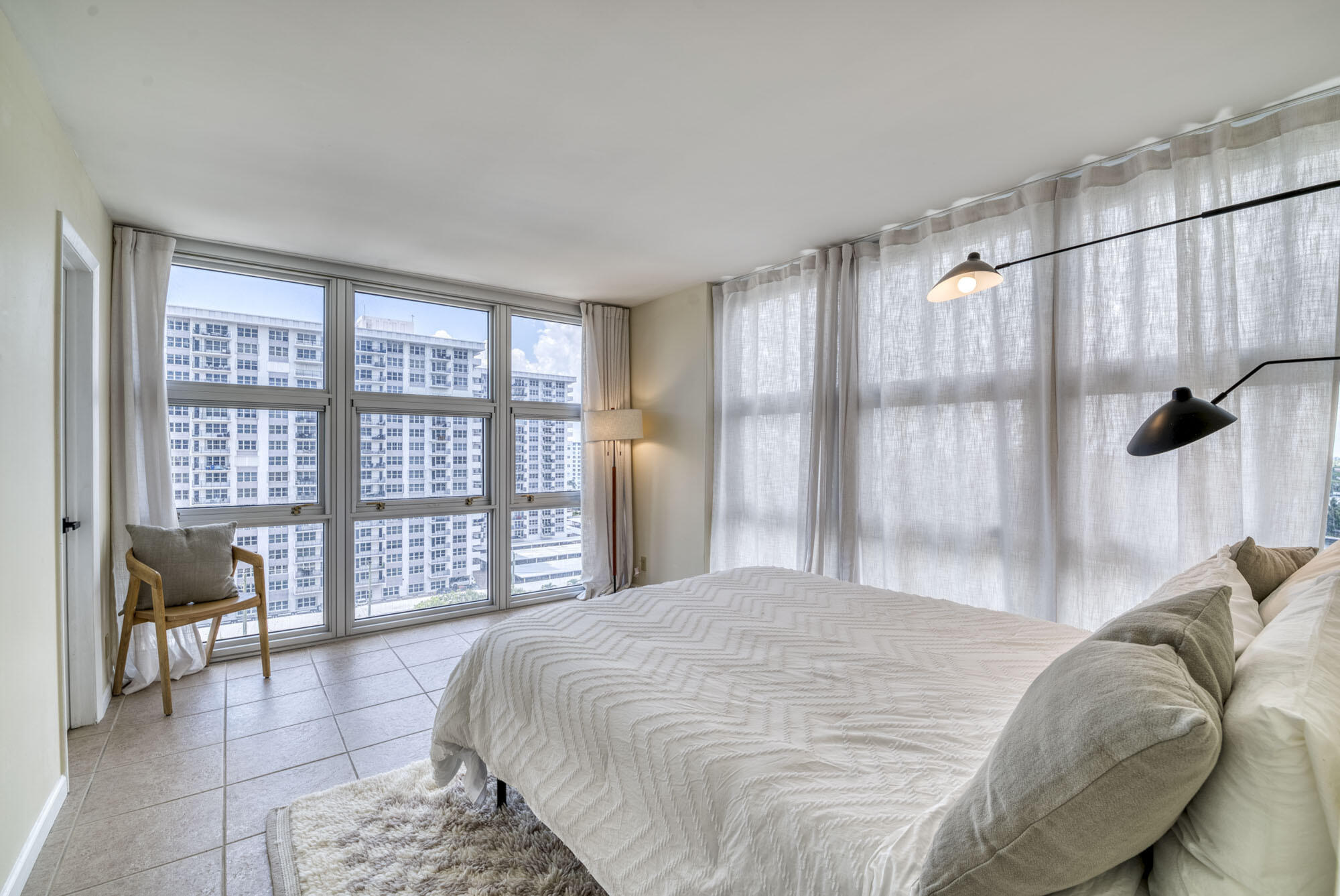 525 North Ocean Boulevard, Unit 1215 Pompano Beach, FL 33062 - Photo 13 of 16 a bedroom with a bed and a large window