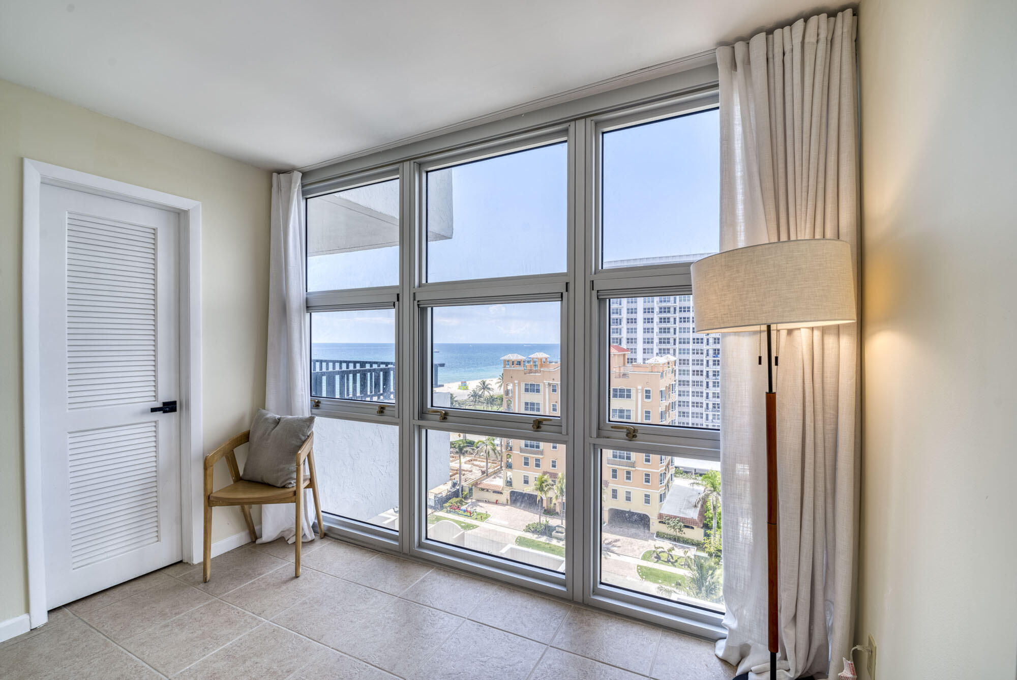 525 North Ocean Boulevard, Unit 1215 Pompano Beach, FL 33062 - Photo 14 of 16 a living room filled with furniture and a window