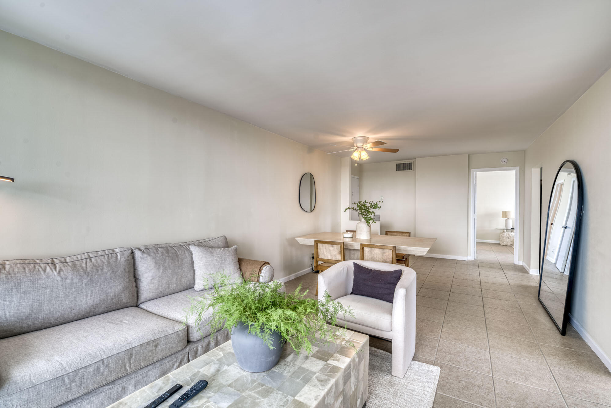 525 North Ocean Boulevard, Unit 1215 Pompano Beach, FL 33062 - Photo 6 of 16 a living room with furniture and a chandelier