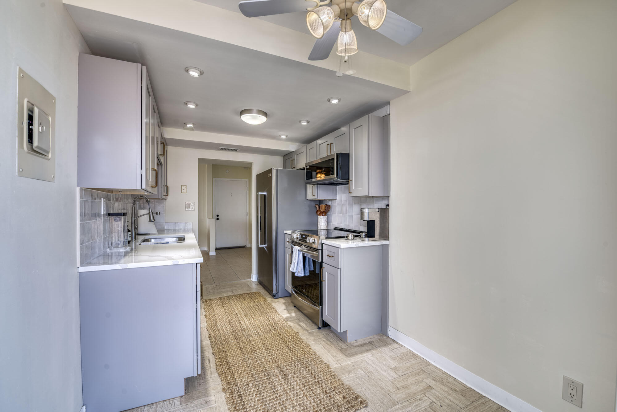 525 North Ocean Boulevard, Unit 1215 Pompano Beach, FL 33062 - Photo 8 of 16 a kitchen with cabinets and stainless steel appliances