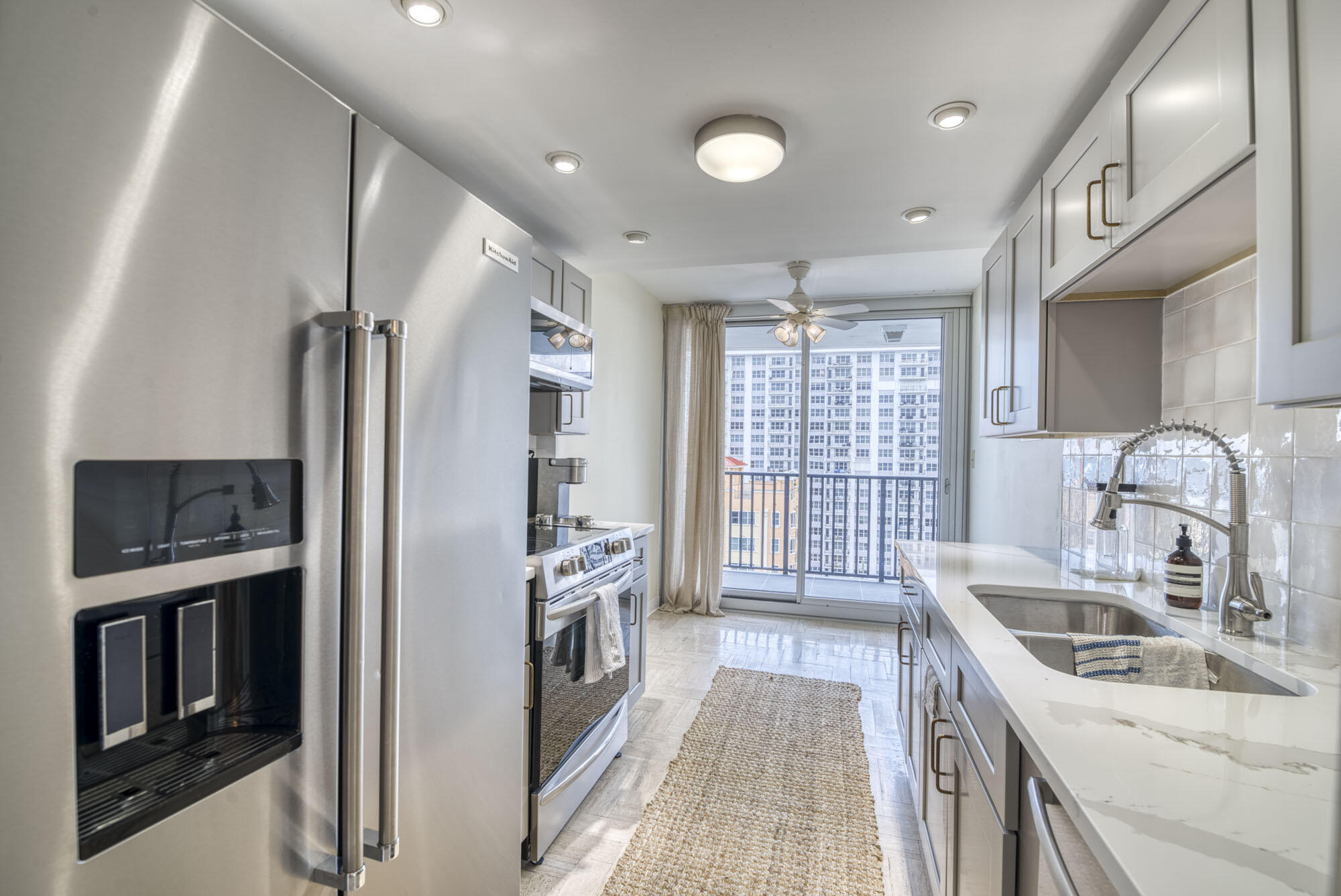 525 North Ocean Boulevard, Unit 1215 Pompano Beach, FL 33062 - Photo 9 of 16 a kitchen with granite countertop a sink stove and refrigerator