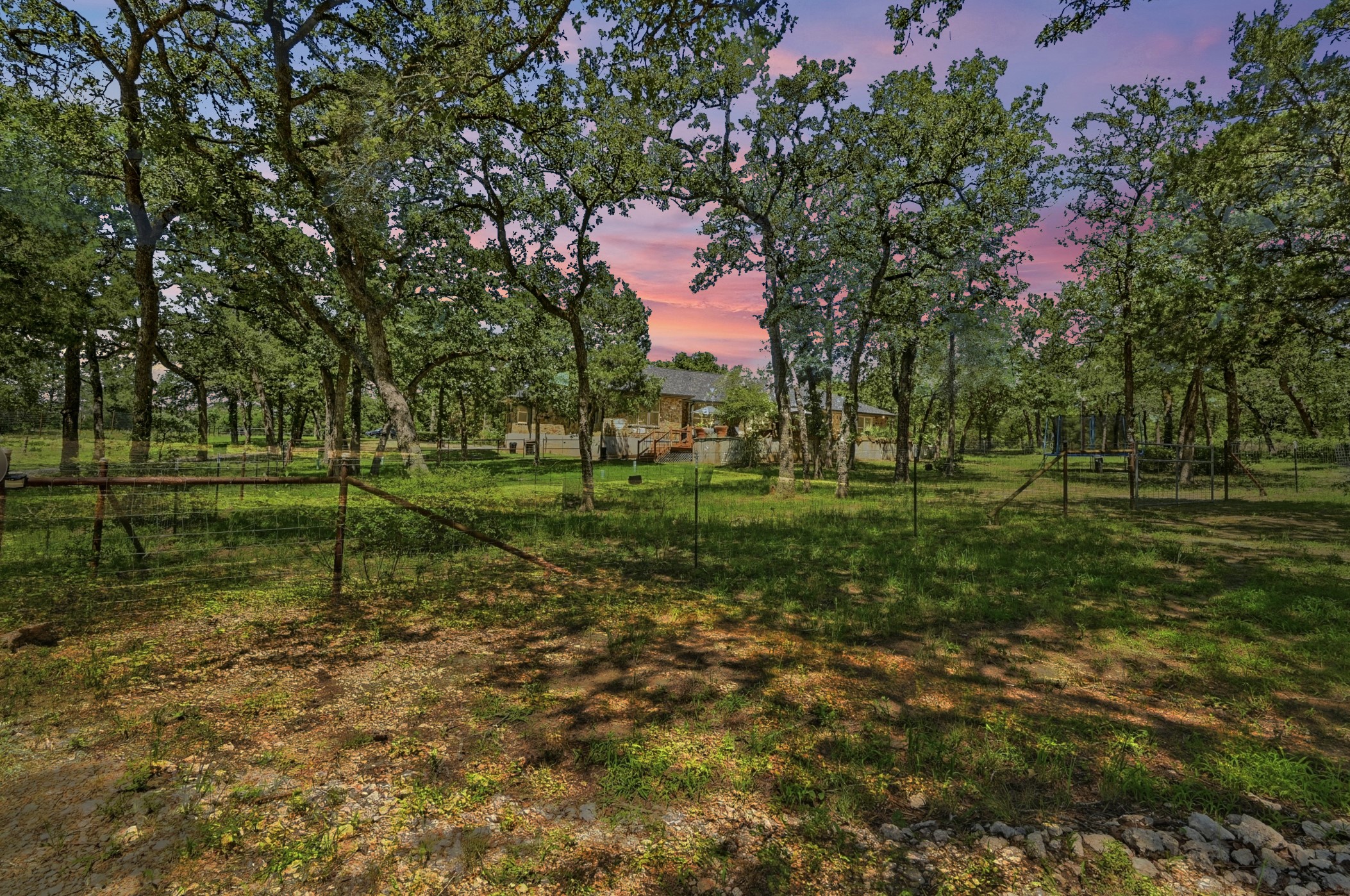 387 Corral Road Smithville, TX 78957 - Photo 32 of 40 Wooded property featuring mature trees and a distant structure