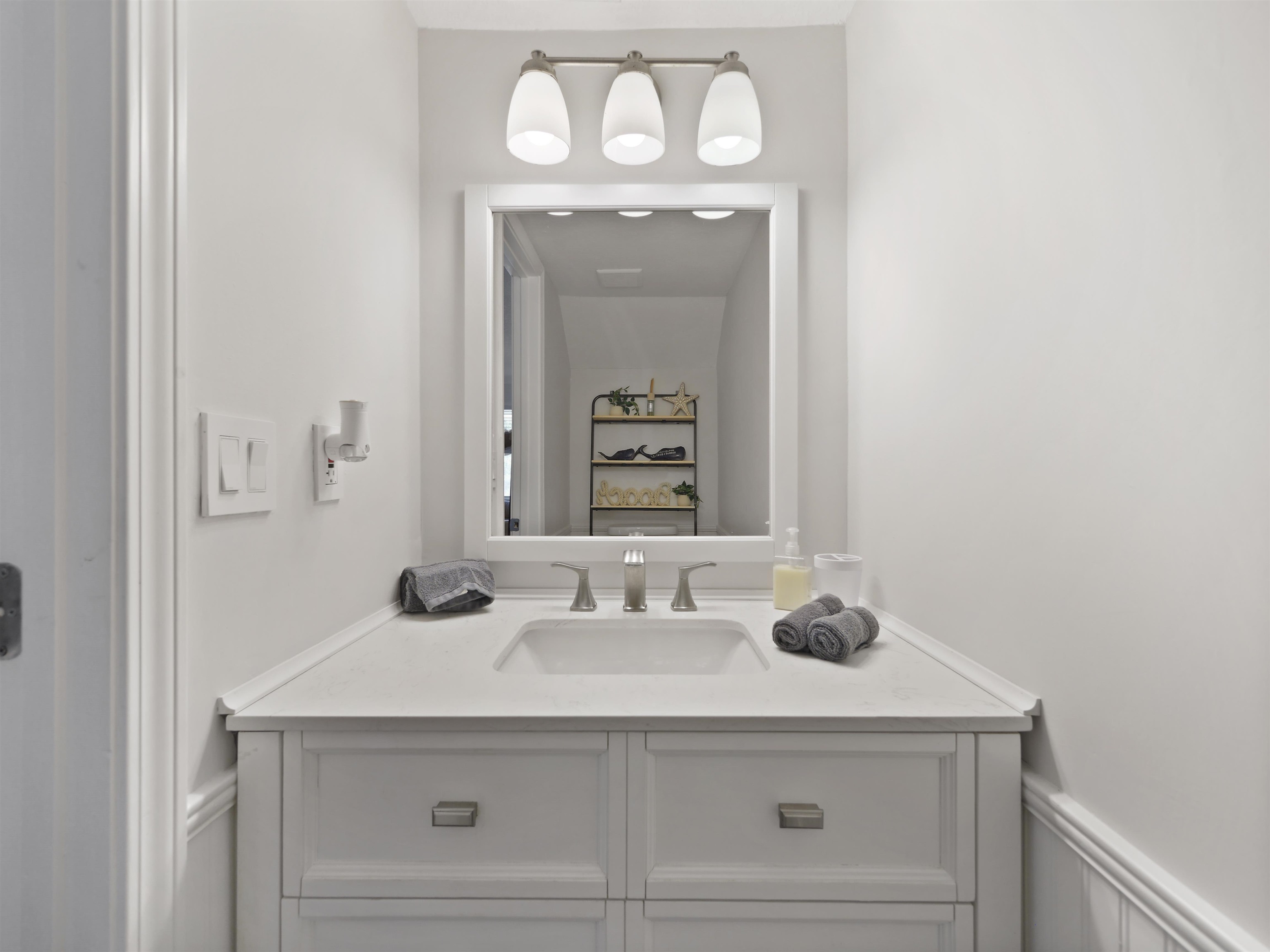 6448 Madison Street St. Augustine, FL 32080 - Photo 18 of 36 a bathroom with a sink and a mirror