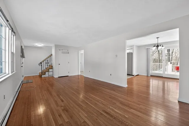 a view of hallway with wooden floor and stairs