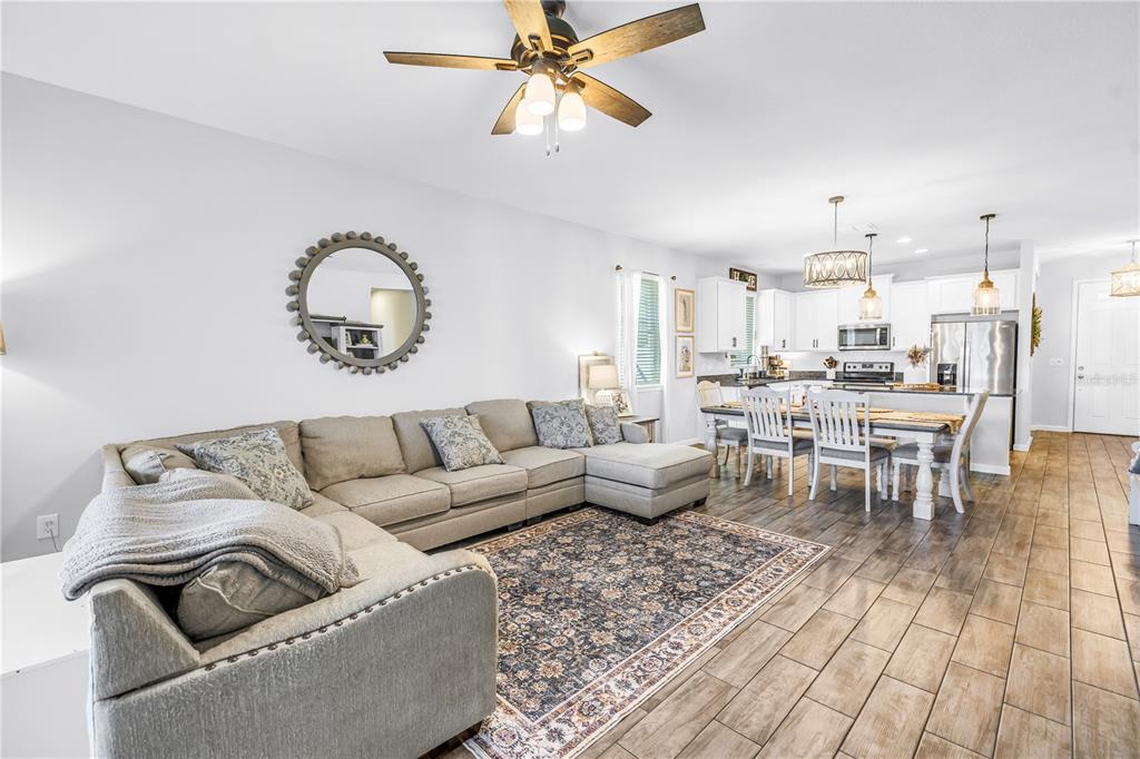 13229 Orca Sound Drive Riverview, FL 33579 - Photo 13 of 37 a living room with furniture and a chandelier