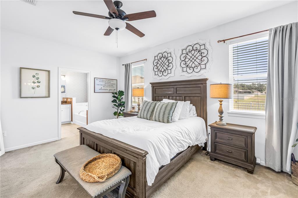 13229 Orca Sound Drive Riverview, FL 33579 - Photo 14 of 37 a bedroom with a bed a dresser and a window
