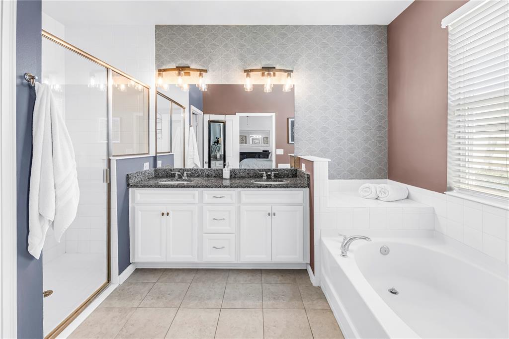 13229 Orca Sound Drive Riverview, FL 33579 - Photo 15 of 37 a bathroom with a bathtub sink and mirror