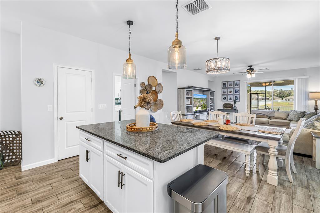 13229 Orca Sound Drive Riverview, FL 33579 - Photo 7 of 37 a kitchen with stainless steel appliances granite countertop a sink a stove and a wooden floors
