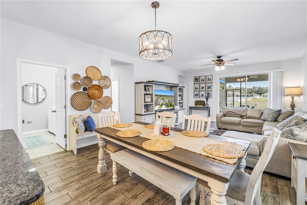 13229 Orca Sound Drive Riverview, FL 33579 - Photo 9 of 37 a view of a dining room with furniture a chandelier and wooden floor