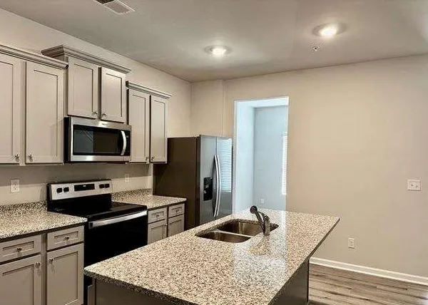 a kitchen with a stove microwave and refrigerator