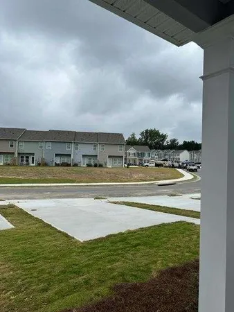 a view of swimming pool with outdoor seating and yard in back