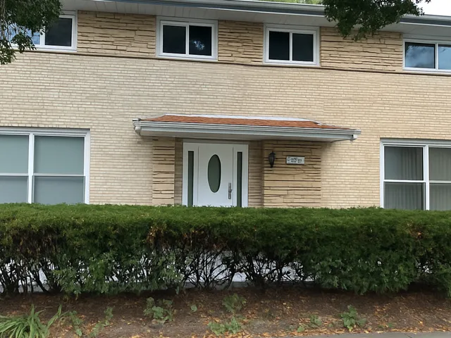 a front view of a house with a garden
