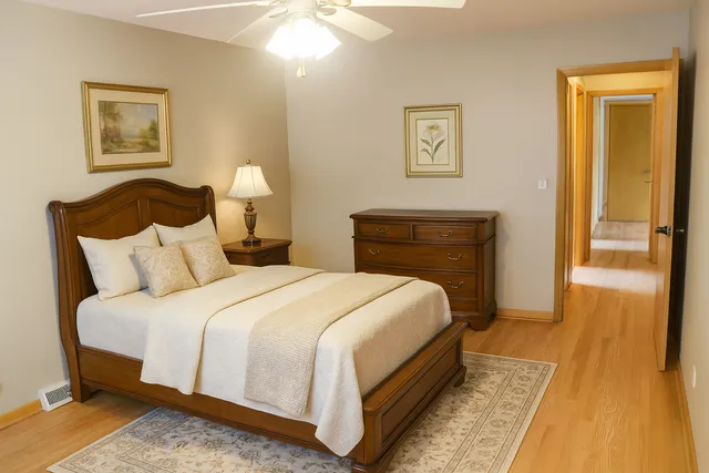 a bedroom with bed and a night stand