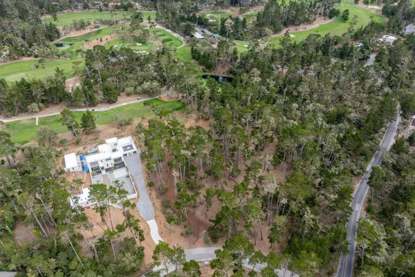 an aerial view of a houses with yard