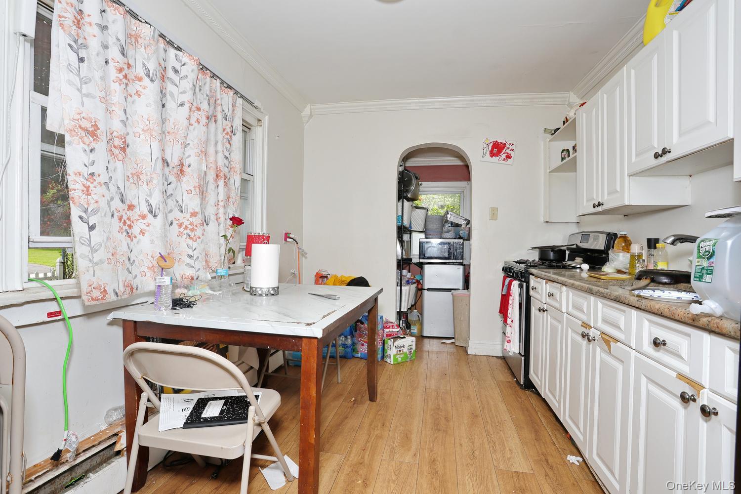 29 Fairview Avenue Spring Valley, NY 10977 - Photo 14 of 19 a kitchen with stainless steel appliances a dining table chairs and a refrigerator