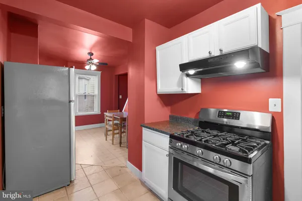 a kitchen with a stove and a refrigerator