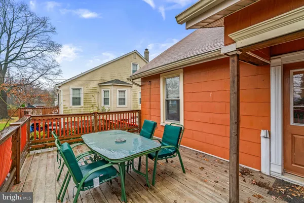 a view of a deck with table and chairs and wooden floor