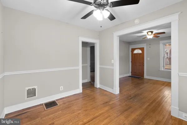 wooden floor in an empty room with a window