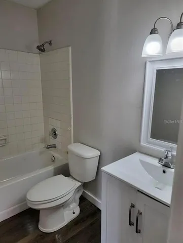 a view of an empty room and wooden floor