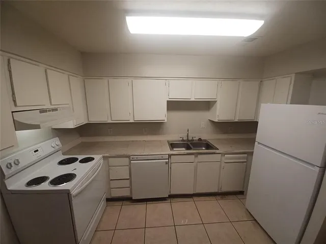 a hallway with a black white checkered floor with a rug