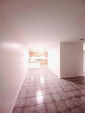 a large white kitchen with a sink and cabinets