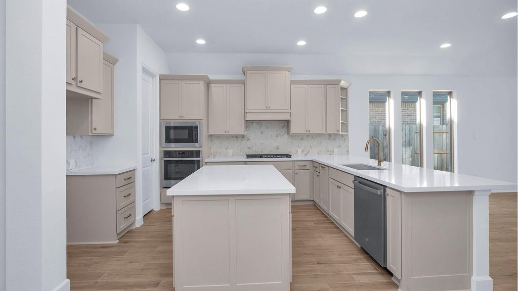 42560 Rustico Road Magnolia, TX 77354 - Photo 4 of 22 a kitchen with a sink stove and refrigerator