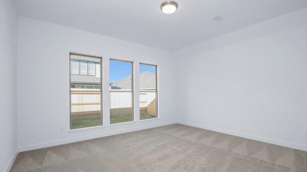42560 Rustico Road Magnolia, TX 77354 - Photo 6 of 22 an empty room with windows