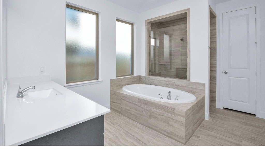 42560 Rustico Road Magnolia, TX 77354 - Photo 7 of 22 a bathroom with a tub a sink and a mirror