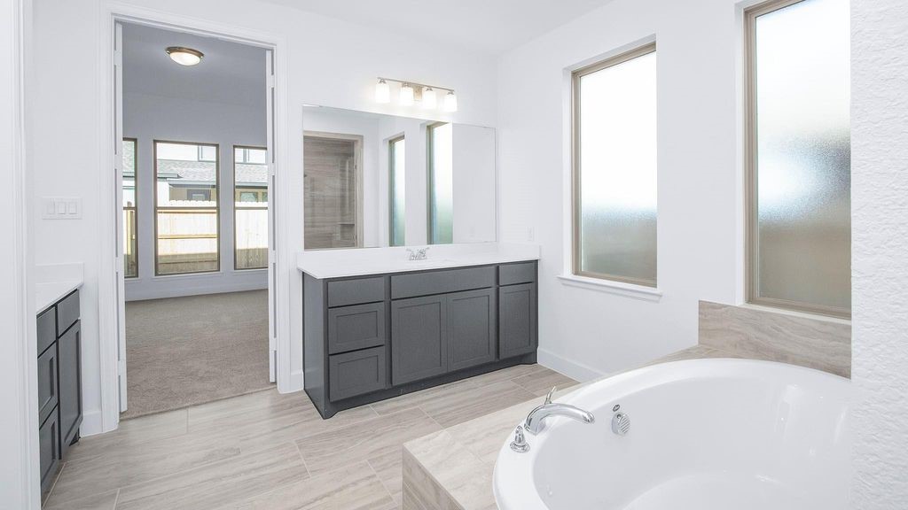 42560 Rustico Road Magnolia, TX 77354 - Photo 8 of 22 a bathroom with a tub sink and mirror