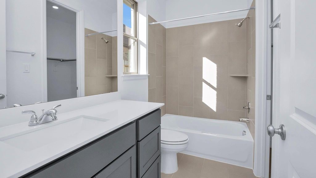 42560 Rustico Road Magnolia, TX 77354 - Photo 10 of 22 a bathroom with a granite countertop sink toilet and shower