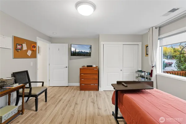 a bedroom with furniture and a wooden floor