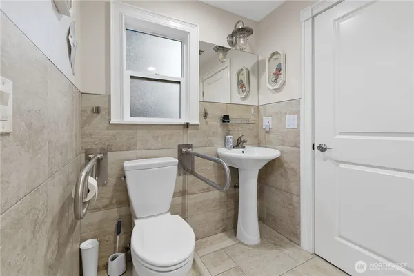a bathroom with a toilet sink and mirror
